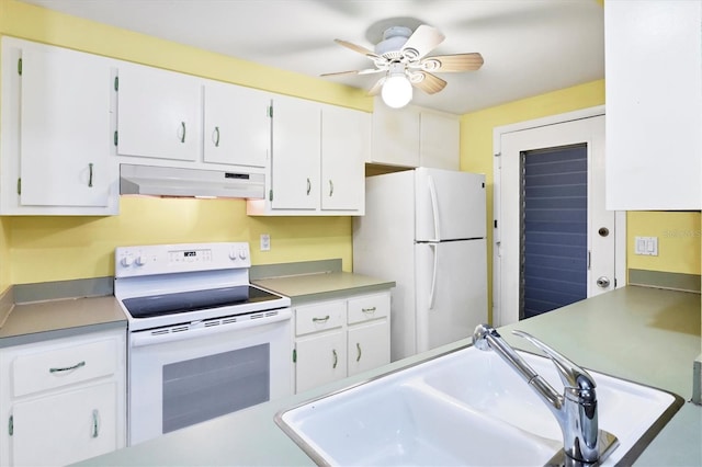 18348 Yale Ave, Port Charlotte, FL 33948 - kitchen featuring under cabinet range hood, white appliances, a sink, and white cabinetry