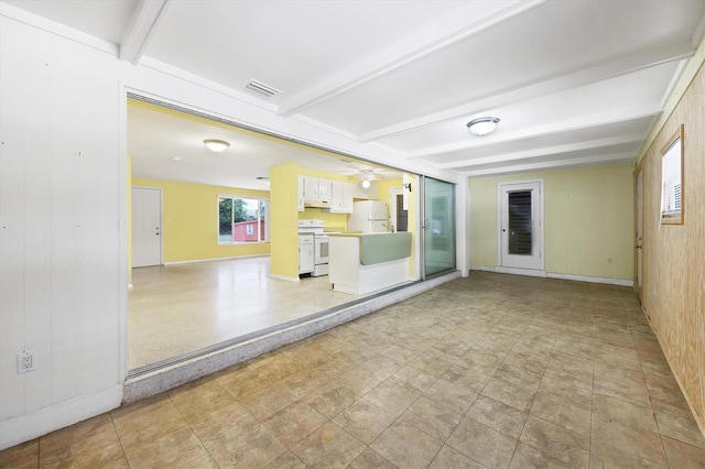 18348 Yale Ave, Port Charlotte, FL 33948 - empty room with beam ceiling, healthy amount of natural light, ceiling fan, baseboards, and wooden walls