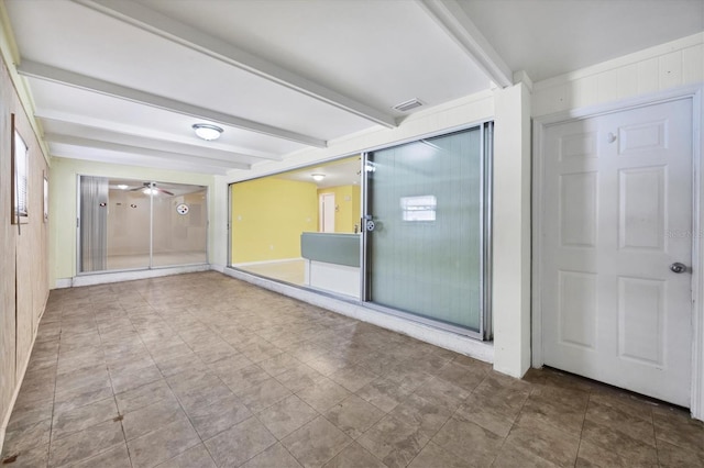 18348 Yale Ave, Port Charlotte, FL 33948 - unfurnished room featuring beam ceiling, a ceiling fan, and wood walls