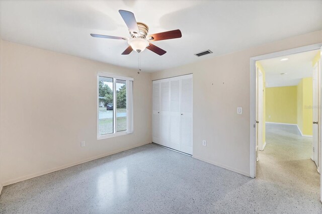 18348 Yale Ave, Port Charlotte, FL 33948 - unfurnished bedroom featuring baseboards, a closet, dark aggregate flooring, and a ceiling fan