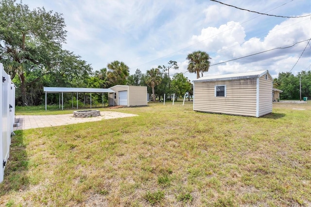 18348 Yale Ave, Port Charlotte, FL 33948 - view of grassy yard with a shed, an outbuilding, an outdoor fire pit, and a patio
