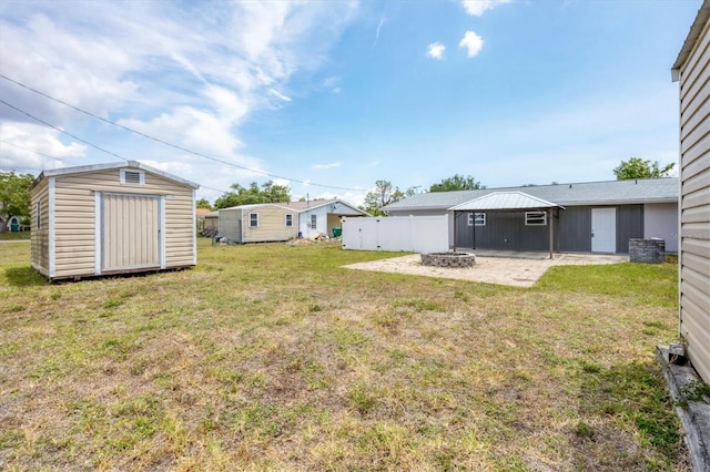 18348 Yale Ave, Port Charlotte, FL 33948 - view of yard with a fire pit, a shed, a patio area, and an outbuilding