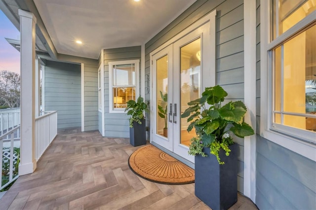 810 Siesta Dr, Sarasota, FL 34242 - exterior entry at dusk with french doors and covered porch