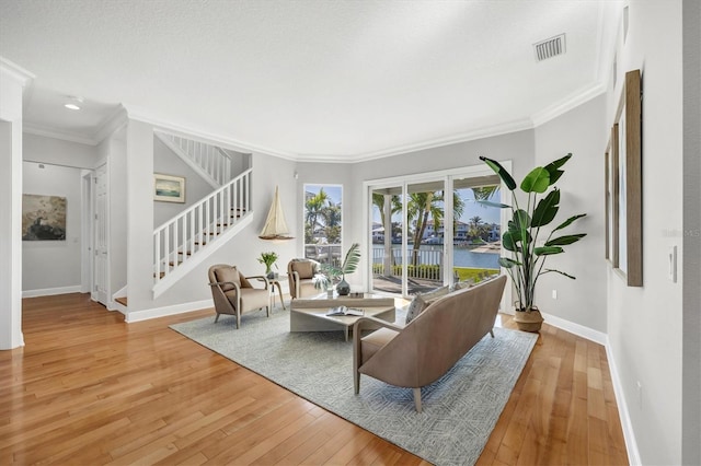 810 Siesta Dr, Sarasota, FL 34242 - living room with stairs, baseboards, wood-type flooring, and ornamental molding