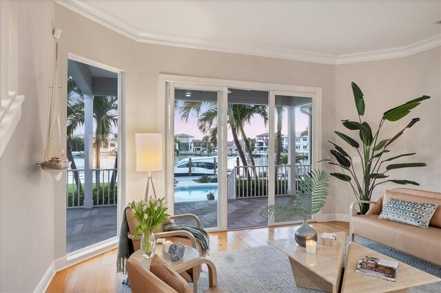 810 Siesta Dr, Sarasota, FL 34242 - living area featuring plenty of natural light, wood finished floors, ornamental molding, and baseboards