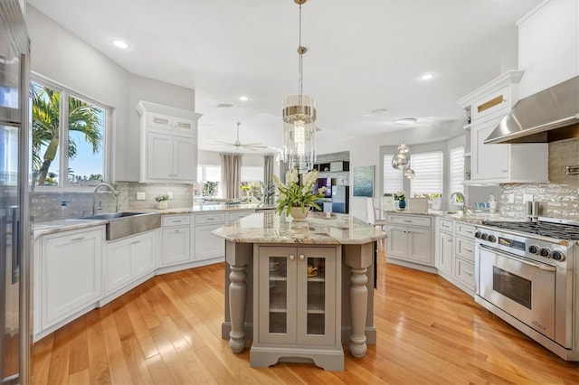 810 Siesta Dr, Sarasota, FL 34242 - kitchen with stainless steel stove, a sink, a peninsula, backsplash, and recessed lighting