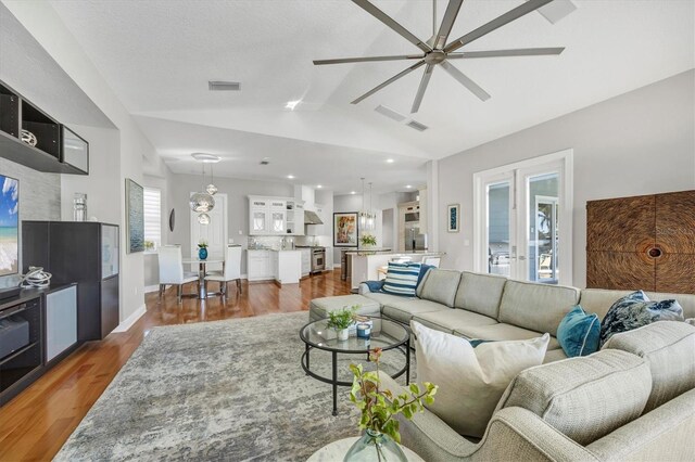 810 Siesta Dr, Sarasota, FL 34242 - living area with a ceiling fan, lofted ceiling, wood finished floors, and recessed lighting