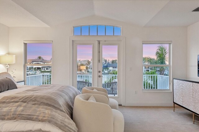 810 Siesta Dr, Sarasota, FL 34242 - bedroom with vaulted ceiling, access to exterior, carpet, french doors, and baseboards