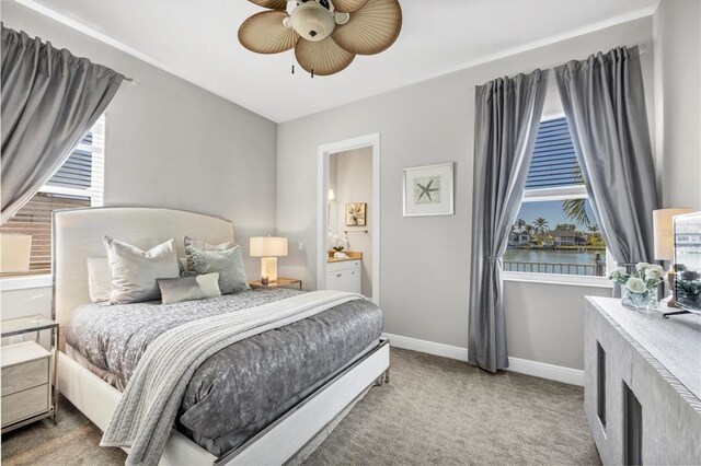 810 Siesta Dr, Sarasota, FL 34242 - bedroom with baseboards, carpet floors, ensuite bathroom, and a ceiling fan