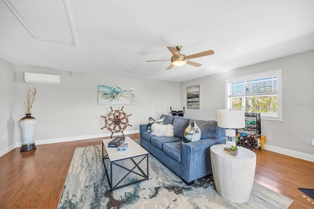 810 Siesta Dr, Sarasota, FL 34242 - living room with an AC wall unit, wood finished floors, ceiling fan, and baseboards
