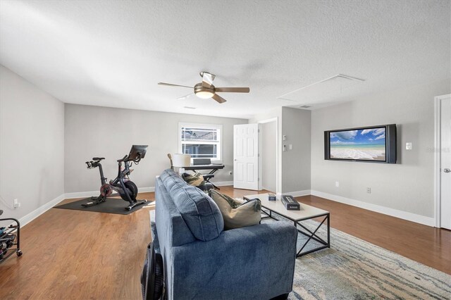 810 Siesta Dr, Sarasota, FL 34242 - living room featuring wood finished floors, attic access, a ceiling fan, baseboards, and a textured ceiling
