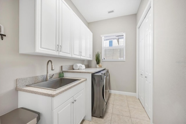 810 Siesta Dr, Sarasota, FL 34242 - washroom featuring separate washer and dryer, cabinet space, light tile patterned floors, and baseboards