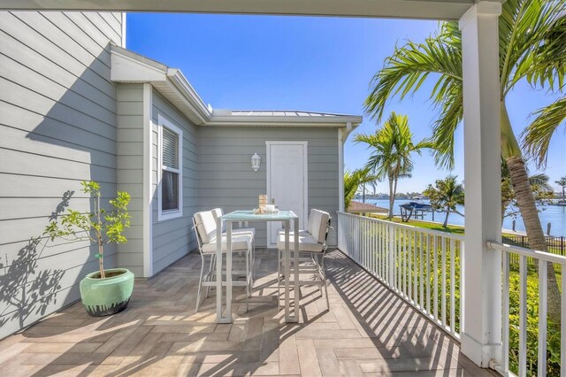 810 Siesta Dr, Sarasota, FL 34242 - deck with a water view, outdoor dining space, and a patio