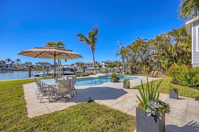 810 Siesta Dr, Sarasota, FL 34242 - outdoor pool featuring a patio, a lawn, and a water view