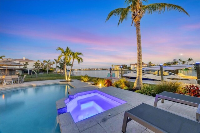 810 Siesta Dr, Sarasota, FL 34242 - view of pool with a patio area, a water view, and a pool with connected hot tub
