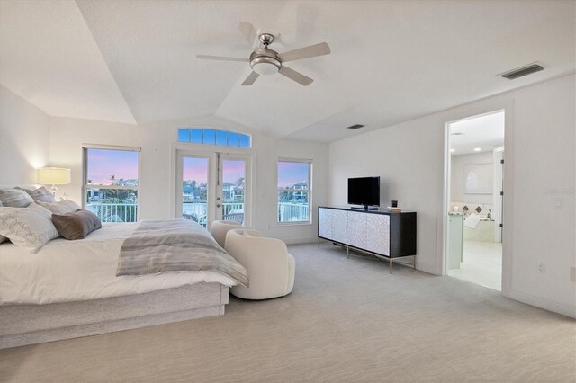 810 Siesta Dr, Sarasota, FL 34242 - carpeted bedroom with access to outside, vaulted ceiling, ensuite bath, ceiling fan, and baseboards