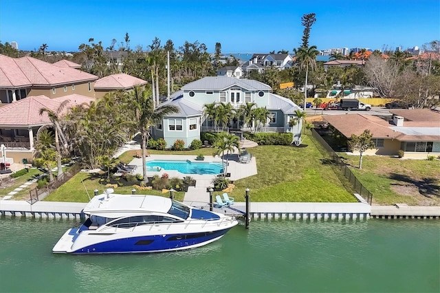 810 Siesta Dr, Sarasota, FL 34242 - rear view of house with a water view, a residential view, and a yard