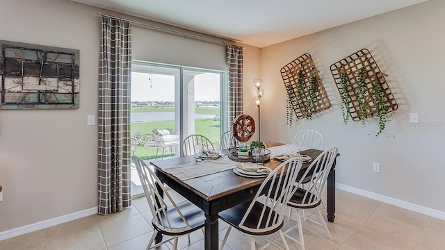 dining area with light tile patterned floors and baseboards