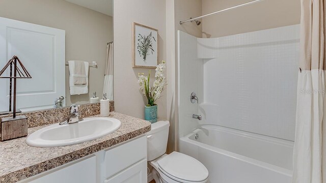 full bath with shower / bathtub combination with curtain, toilet, and vanity