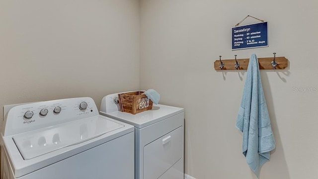 laundry room featuring washing machine and clothes dryer and laundry area