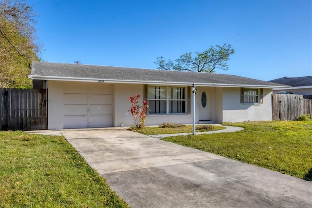 ranch-style house featuring stucco siding, a front yard, a garage, and fence