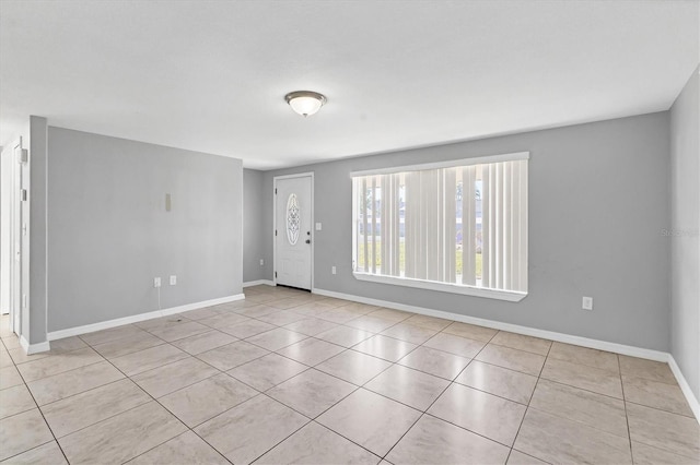 unfurnished room featuring baseboards