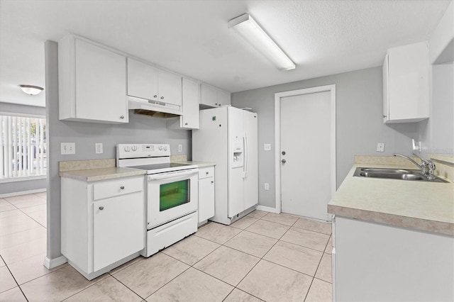 kitchen with a sink, under cabinet range hood, white appliances, white cabinets, and light countertops