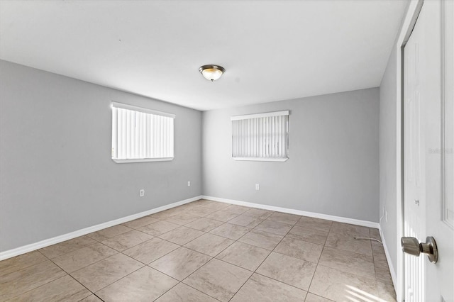 empty room featuring baseboards