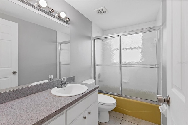 full bath with vanity, visible vents, tile patterned floors, toilet, and combined bath / shower with glass door