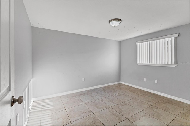 tiled empty room with baseboards