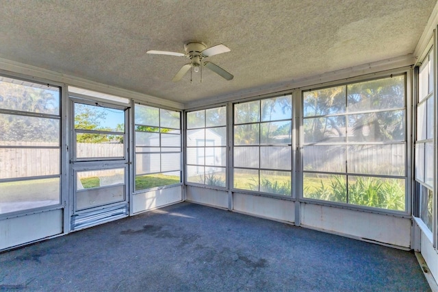 unfurnished sunroom with a ceiling fan