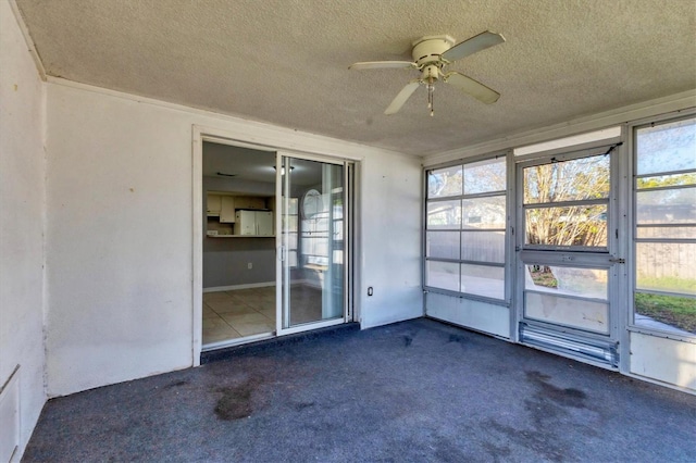 unfurnished sunroom with a ceiling fan