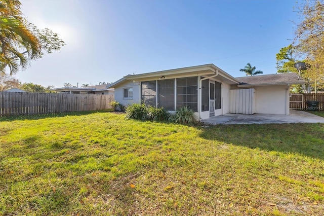 back of property with a patio area, a yard, fence, and stucco siding