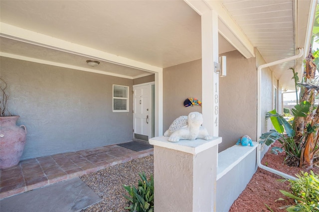 doorway to property featuring stucco siding