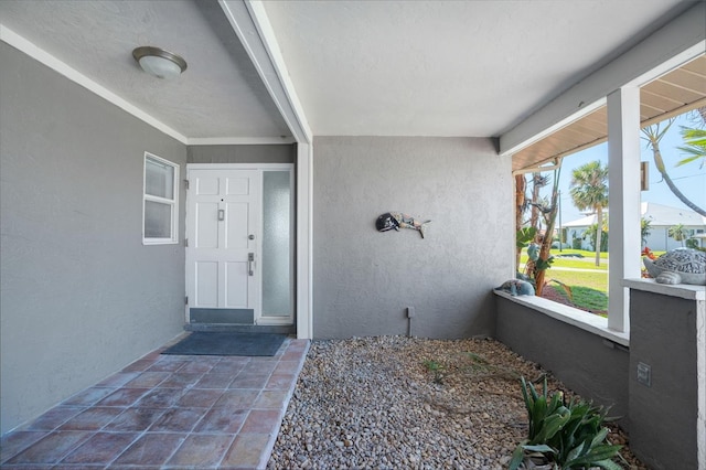 view of exterior entry with stucco siding