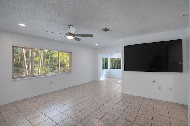 unfurnished room featuring light tile patterned floors, plenty of natural light, ceiling fan, and visible vents