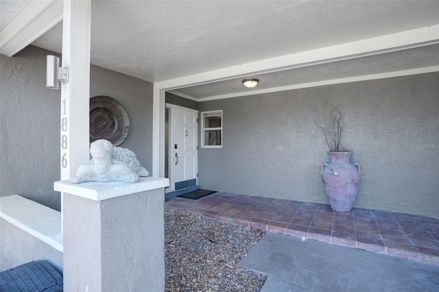 entrance to property with stucco siding