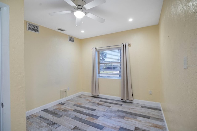 unfurnished room with visible vents, baseboards, and wood finished floors