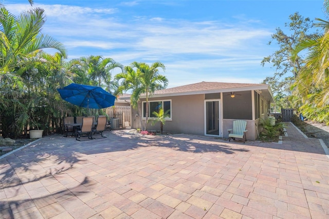 exterior space with central air condition unit, outdoor dining area, fence, and ceiling fan