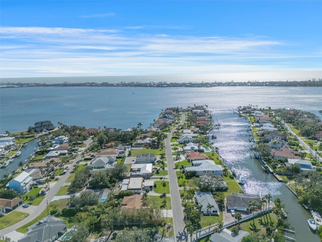 drone / aerial view featuring a residential view and a water view