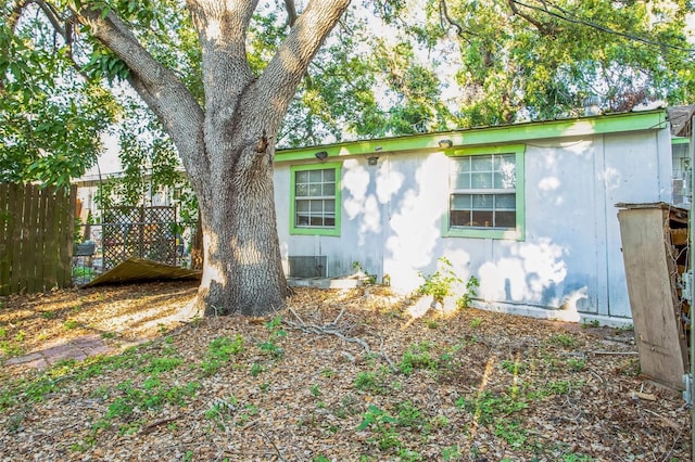 view of side of property featuring fence