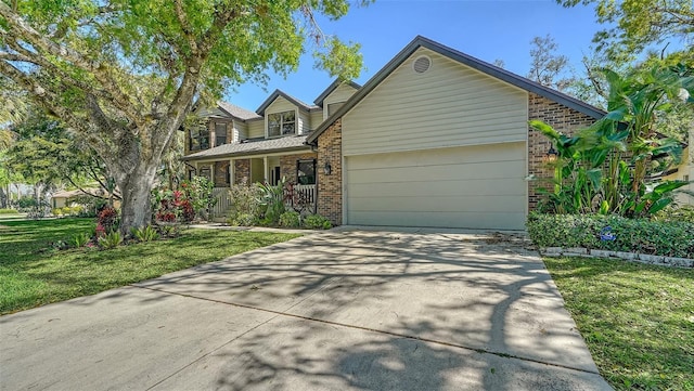 view of front of house featuring brick siding, a front lawn, a porch, a garage, and driveway