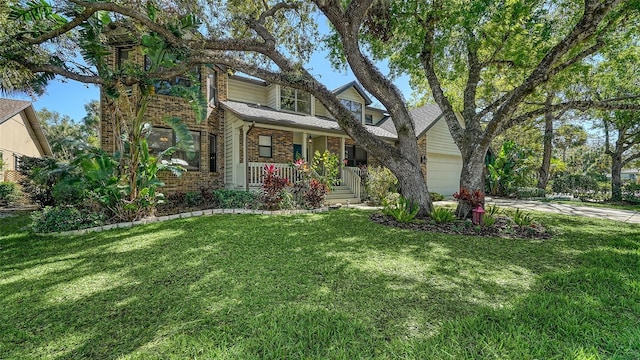 view of front of property featuring a front yard, a shingled roof, concrete driveway, a garage, and brick siding