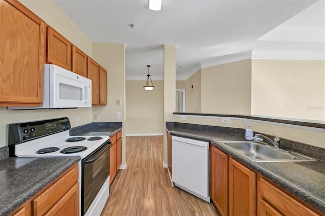 kitchen featuring a sink, white appliances, and dark countertops