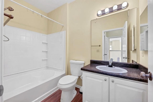 full bath with tub / shower combination, toilet, vanity, and wood finished floors