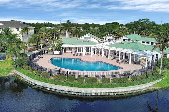 exterior space featuring a water view, fence, and a patio area