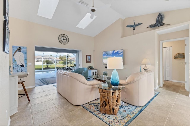 living room featuring light tile patterned floors, baseboards, visible vents, high vaulted ceiling, and a skylight