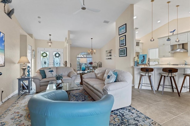 living area with visible vents, high vaulted ceiling, french doors, light tile patterned floors, and baseboards