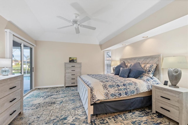 bedroom with baseboards, ceiling fan, access to exterior, a raised ceiling, and light colored carpet