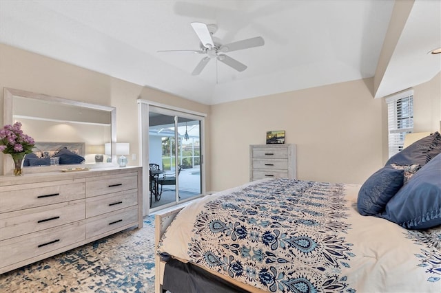 bedroom featuring a raised ceiling, a ceiling fan, and access to outside